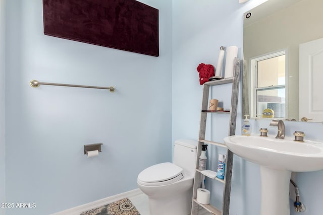 bathroom with tile patterned floors, toilet, and sink