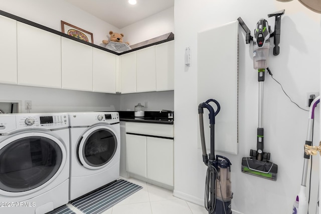 washroom featuring cabinets, light tile patterned floors, sink, and washing machine and clothes dryer