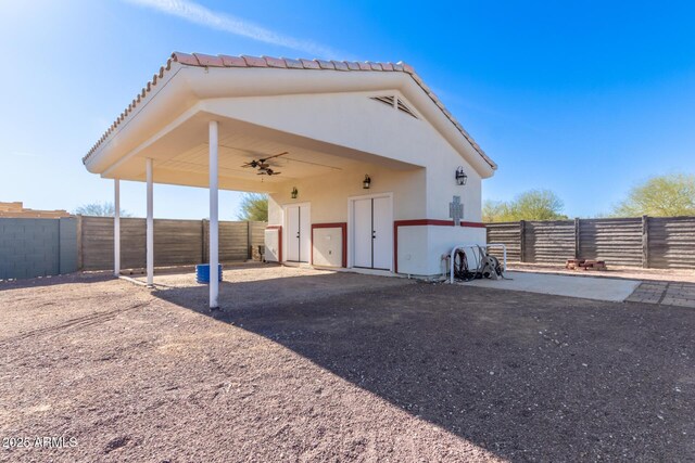 back of house with ceiling fan