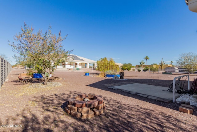 view of yard featuring an outdoor fire pit