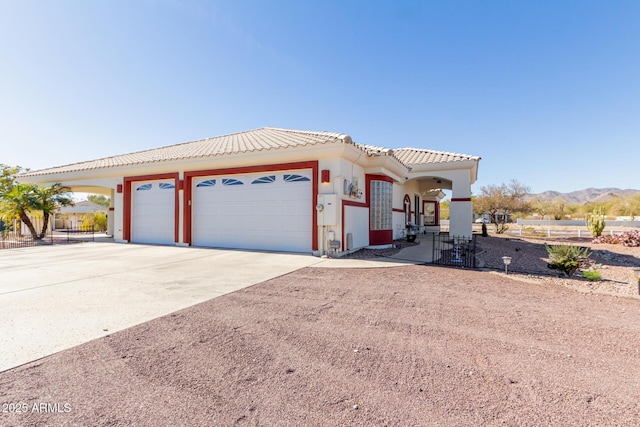 view of front of property featuring a mountain view and a garage