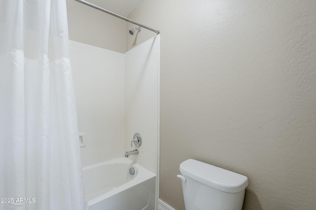 full bath featuring toilet, shower / tub combo, and a textured wall