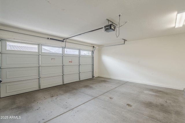 garage featuring baseboards and a garage door opener
