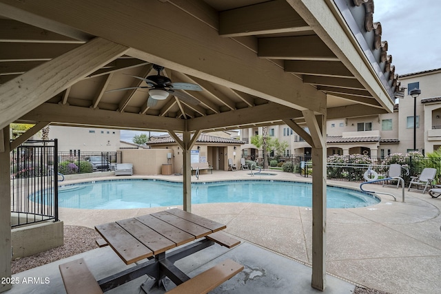 community pool with a gazebo, a patio, ceiling fan, and fence