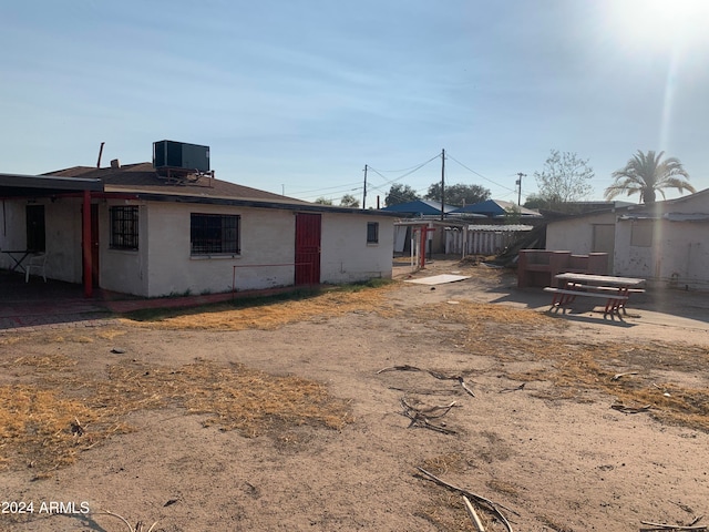 rear view of house featuring central air condition unit and a patio area