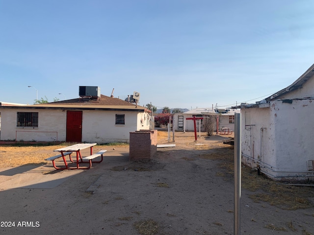 rear view of house with a patio and central air condition unit