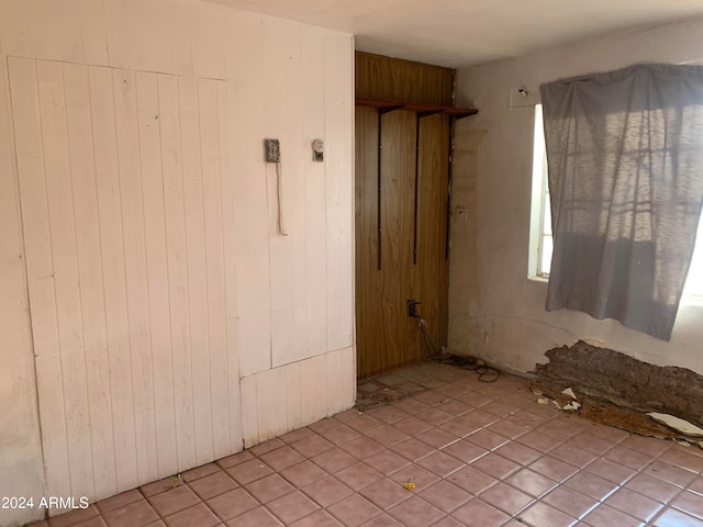 unfurnished bedroom with wooden walls