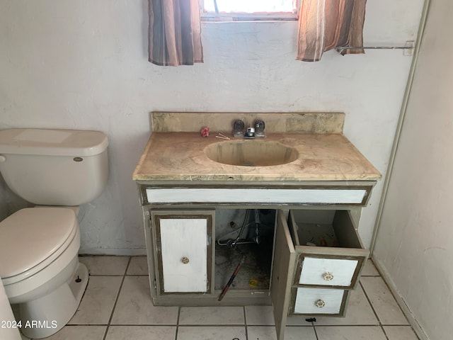 bathroom featuring tile patterned flooring, vanity, and toilet