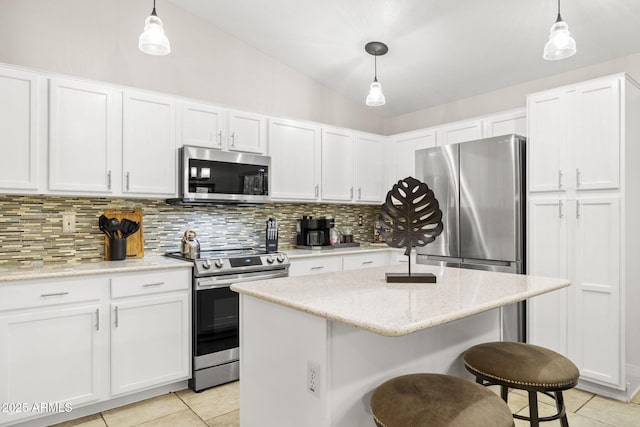 4111 S Dewdrop Ct, Gilbert, AZ 85297 - kitchen with stainless steel appliances, light tile patterned flooring, decorative backsplash, white cabinetry, and a breakfast bar