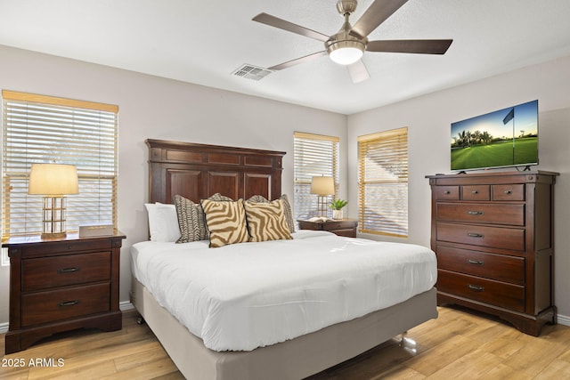 4111 S Dewdrop Ct, Gilbert, AZ 85297 - bedroom with light wood-style floors, multiple windows, and a ceiling fan