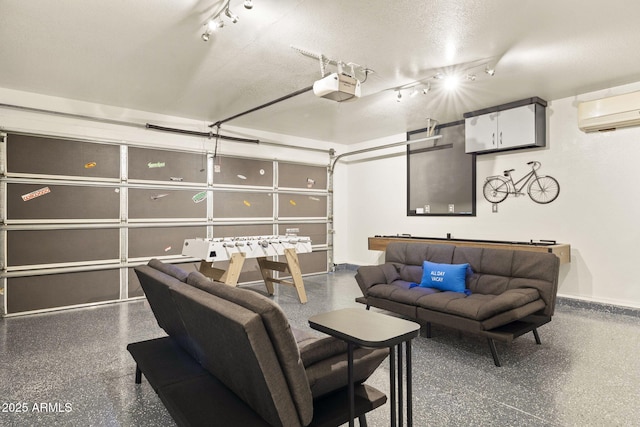 4111 S Dewdrop Ct, Gilbert, AZ 85297 - home theater featuring speckled floor, rail lighting, a wall unit AC, and a garage