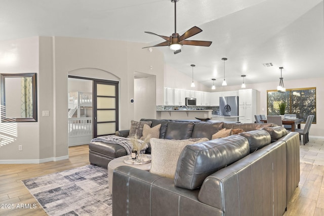 4111 S Dewdrop Ct, Gilbert, AZ 85297 - living room featuring ceiling fan, lofted ceiling, and light wood-style floors