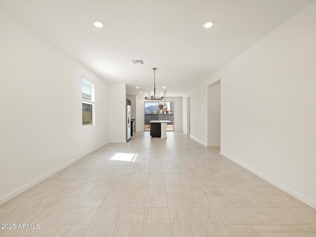 interior space with baseboards, visible vents, a chandelier, and recessed lighting