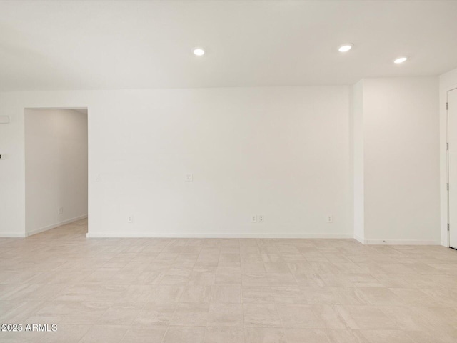 empty room with baseboards and recessed lighting