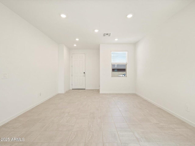 empty room featuring visible vents, baseboards, and recessed lighting