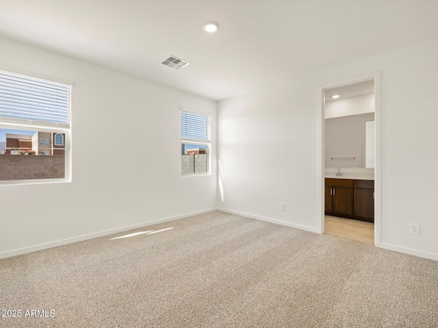 unfurnished bedroom with recessed lighting, baseboards, visible vents, and light colored carpet