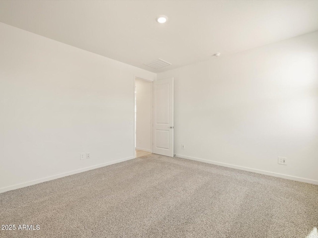 carpeted empty room with baseboards and recessed lighting