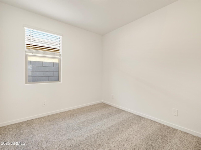 carpeted empty room with baseboards