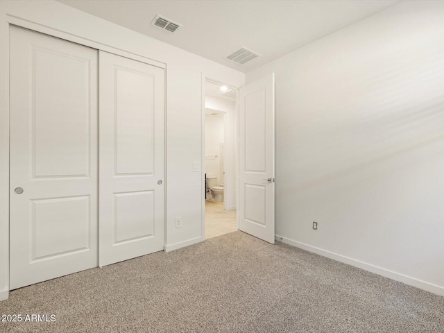 unfurnished bedroom featuring light carpet, baseboards, and visible vents