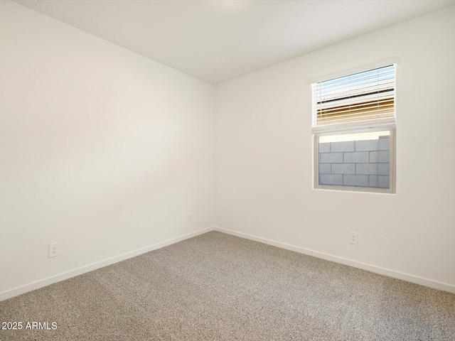 unfurnished room with carpet floors and baseboards