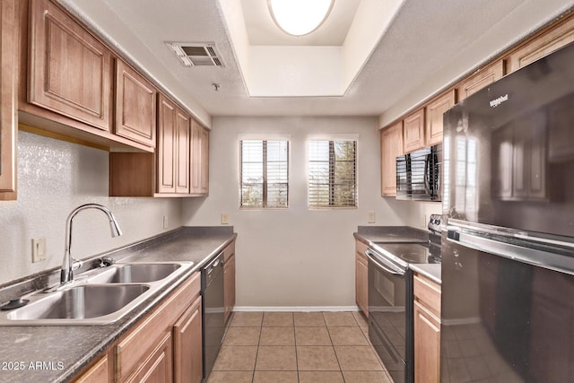 3434 E Baseline Rd Unit 214, Phoenix, AZ 85042 - kitchen featuring black appliances, a sink, baseboards, light tile patterned floors, and dark countertops