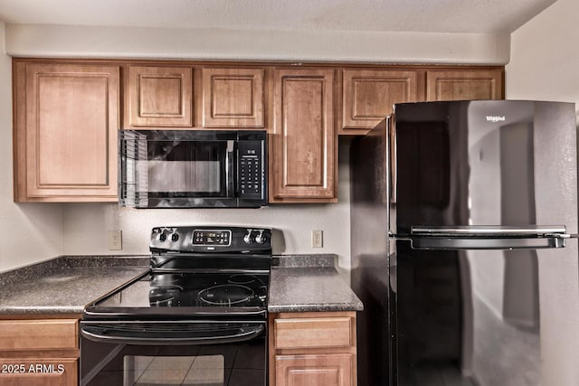 3434 E Baseline Rd Unit 214, Phoenix, AZ 85042 - kitchen with black appliances, dark countertops, brown cabinetry, and tile patterned floors