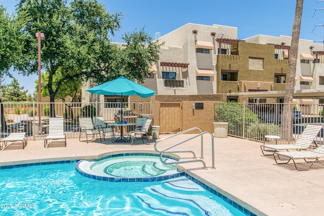 3434 E Baseline Rd Unit 214, Phoenix, AZ 85042 - view of swimming pool featuring a pool with connected hot tub and a patio area