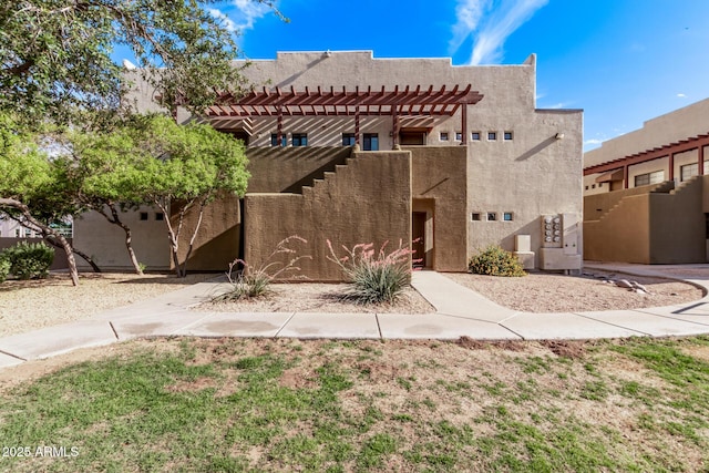 3434 E Baseline Rd Unit 214, Phoenix, AZ 85042 - pueblo revival-style home with stucco siding and a pergola