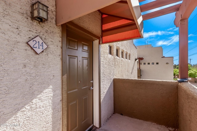 3434 E Baseline Rd Unit 214, Phoenix, AZ 85042 - view of exterior entry with a balcony and stucco siding