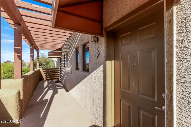 3434 E Baseline Rd Unit 214, Phoenix, AZ 85042 - view of exterior entry with a pergola and stucco siding