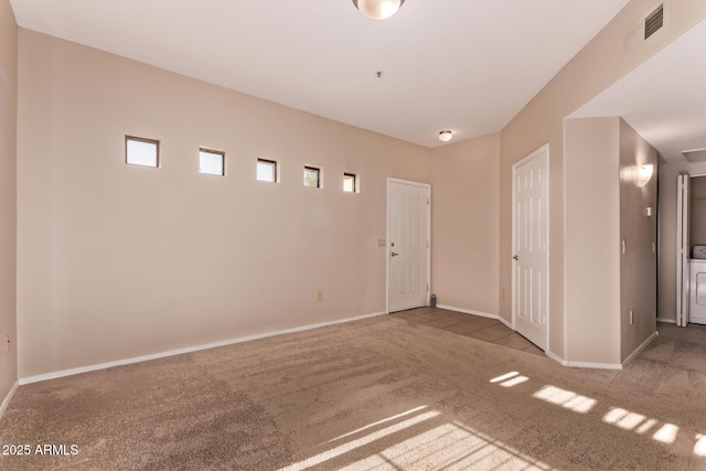 3434 E Baseline Rd Unit 214, Phoenix, AZ 85042 - carpeted empty room with baseboards and washer / dryer