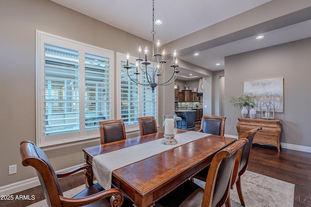 dining room with recessed lighting, dark wood finished floors, baseboards, and an inviting chandelier