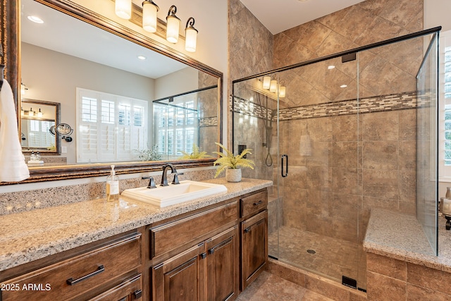 bathroom featuring a stall shower and vanity