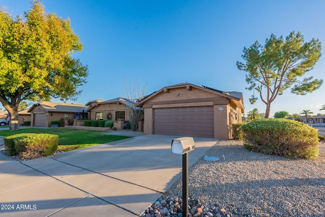 view of front of house featuring a front yard and a garage