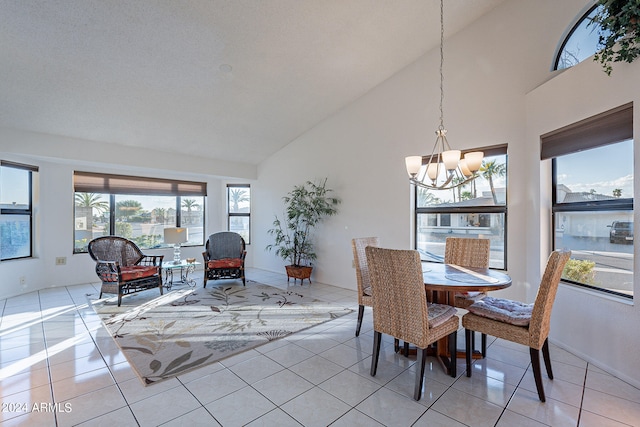 dining area featuring a notable chandelier, high vaulted ceiling, and light tile patterned floors