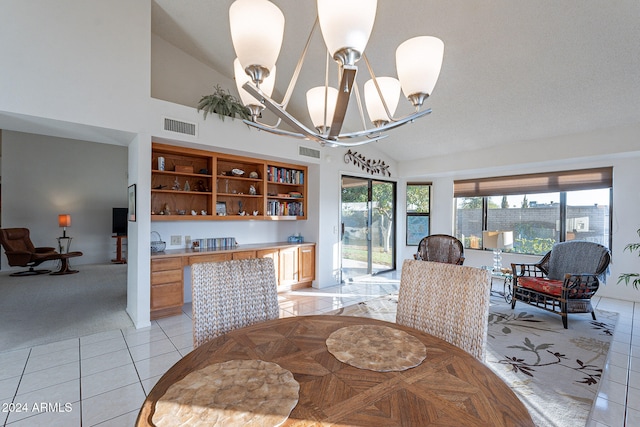 dining space featuring a notable chandelier, light tile patterned flooring, and vaulted ceiling