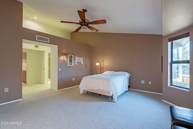 bedroom with light carpet, a textured ceiling, and ceiling fan