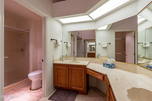 bathroom featuring vanity, toilet, and walk in shower