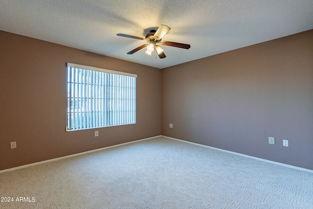 unfurnished room featuring carpet and a textured ceiling