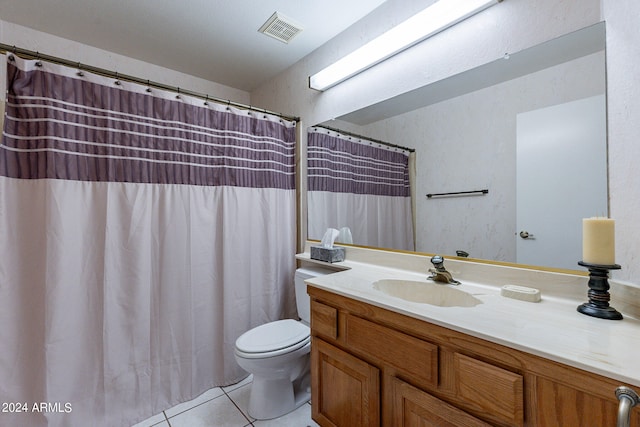 bathroom featuring vanity, toilet, and tile patterned flooring