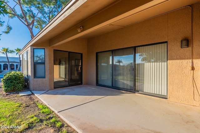 view of exterior entry featuring a patio