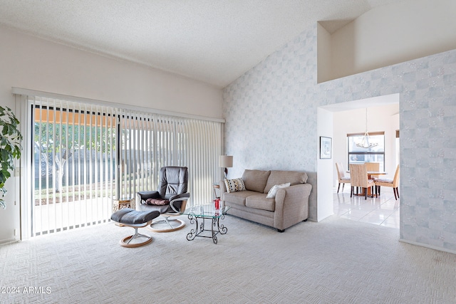 carpeted living room with lofted ceiling, a chandelier, and a textured ceiling