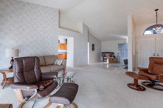 living room featuring a chandelier, light colored carpet, and high vaulted ceiling