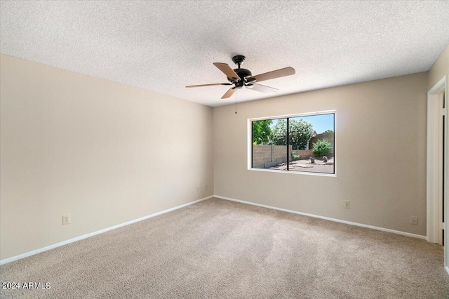 unfurnished room with ceiling fan, carpet floors, and a textured ceiling