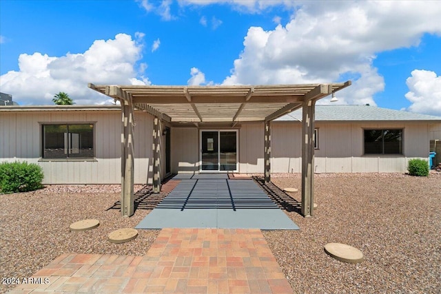 back of property featuring a pergola