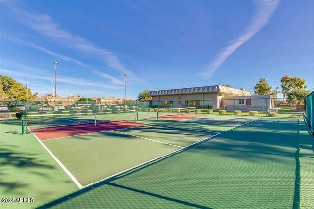 view of tennis court with basketball hoop