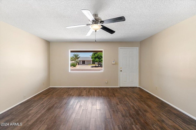 spare room with a textured ceiling, ceiling fan, and dark wood-type flooring