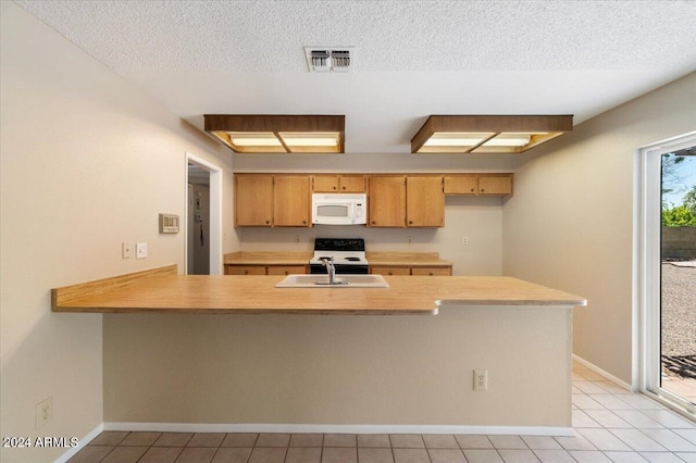 kitchen featuring kitchen peninsula, a textured ceiling, sink, range, and light tile patterned flooring