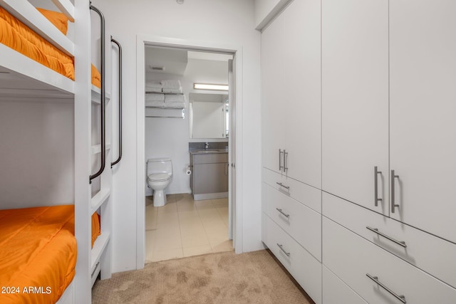 interior space with sink and light colored carpet