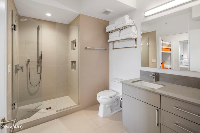 bathroom with vanity, an enclosed shower, toilet, and tile patterned flooring